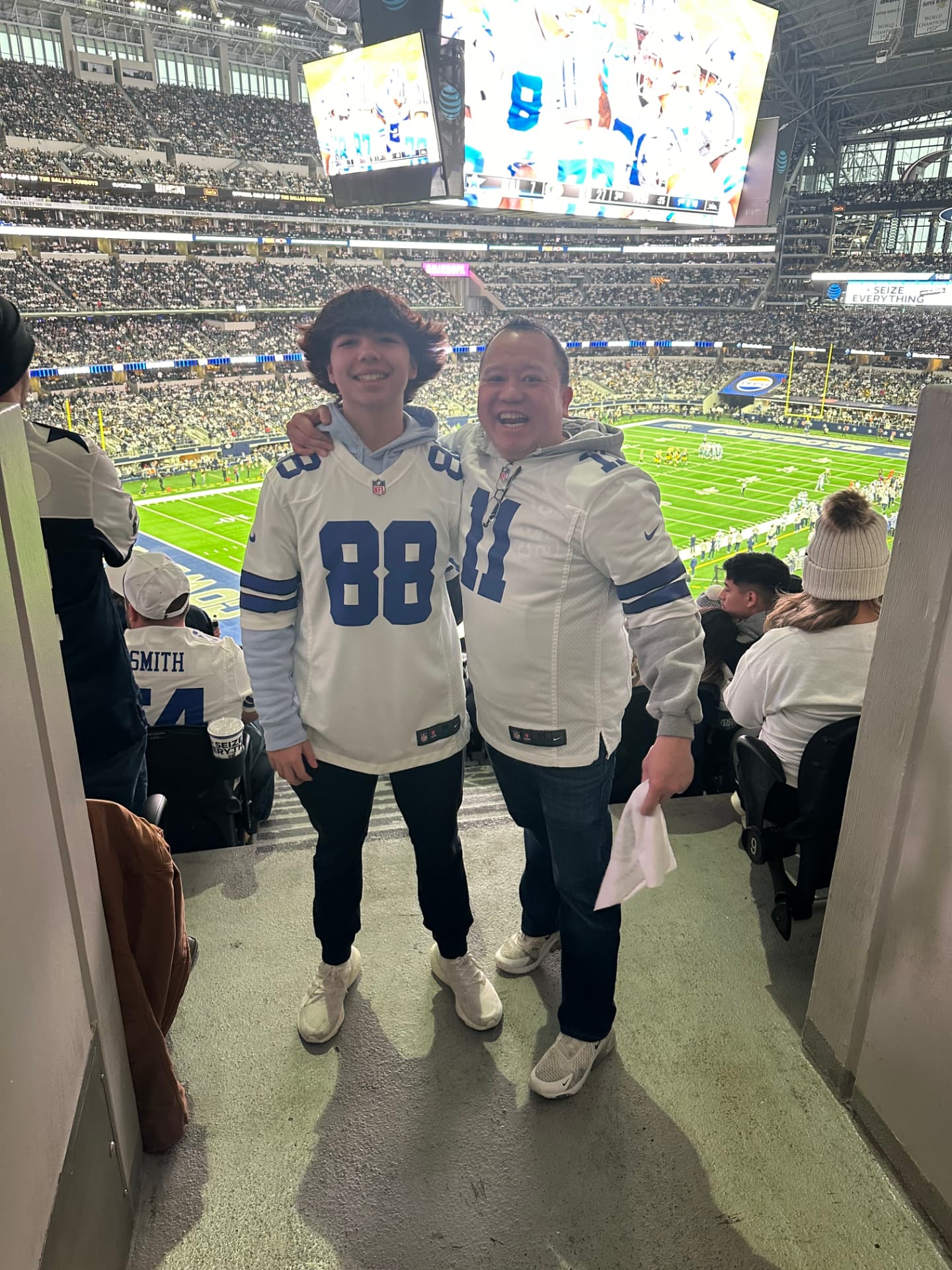 David Nguyen and his son at a Dallas Cowboys game at AT&T Stadium